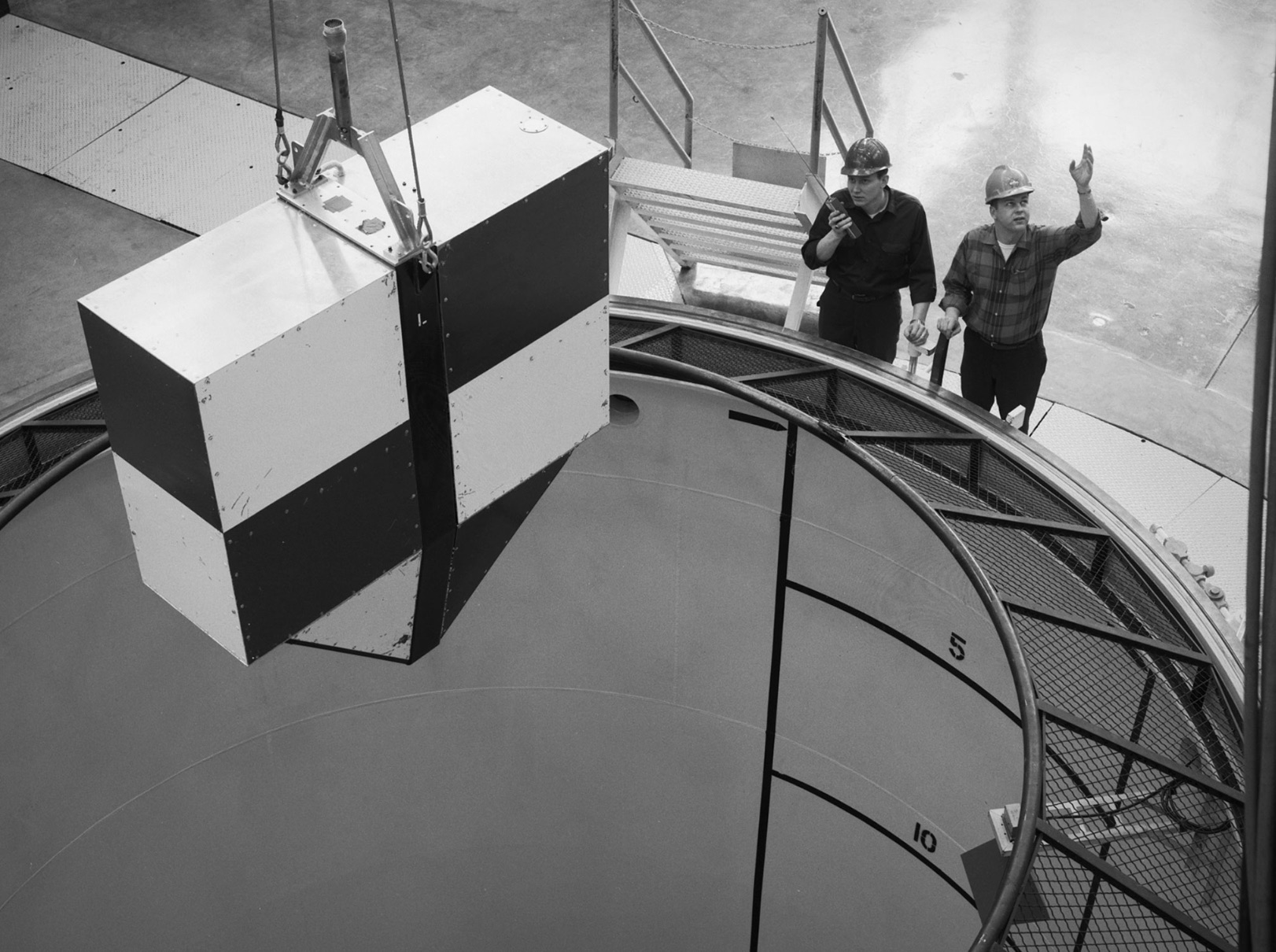 A rectangular drop test vehicle perched above 450-foot shaft at the Zero Gravity Research Facility 